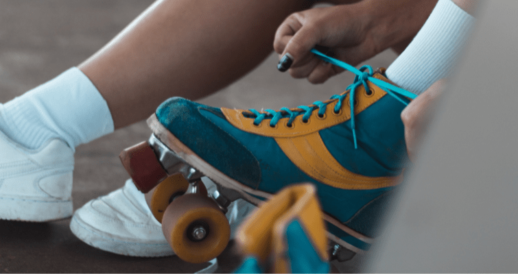 Person tying laces on roller boots