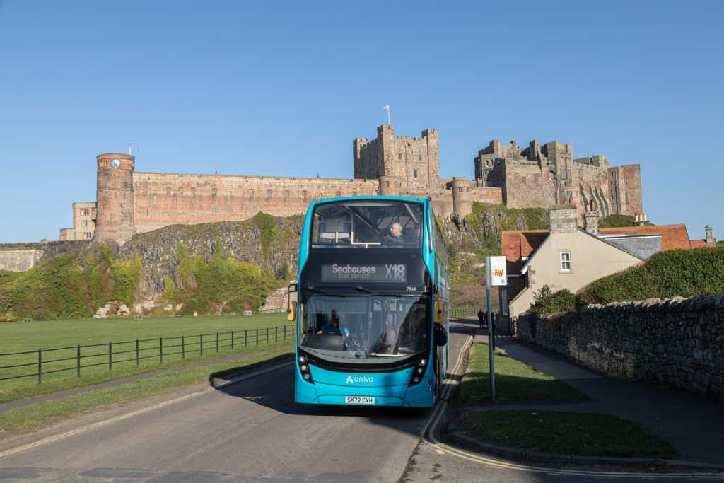 Arriva Service X18 Bus with Bamburgh Castle behind